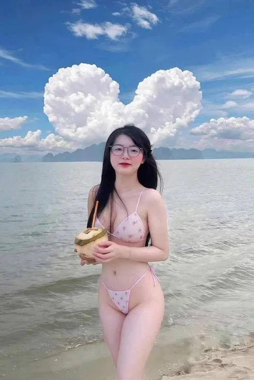 36 Nàng bikini hồng đứng dưới mây, tóc dài, dáng thẳng, ánh sáng lấp lánh.