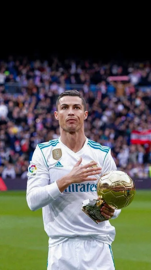 20 Trên sân, áo trắng Real Madrid cầm quả bóng vàng, khán đài phía sau tạo chiều sâu tự nhiên.