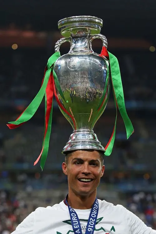 32 Ronaldo cầm cúp bên cờ quốc gia, màu đỏ xanh nổi, cảm giác tự hào lan mạnh