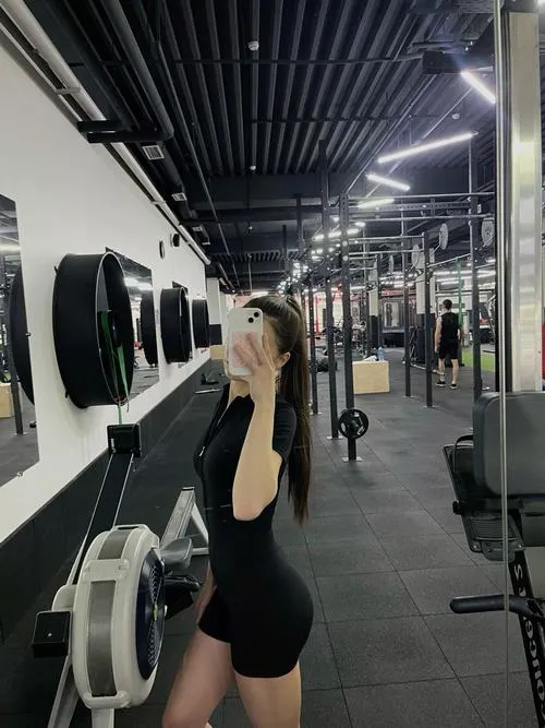 16 Ảnh cô gái vừa kết thúc bài squat ở khu tập mông đùi để lộ vòng ba đầy đặn và dáng vẻ tự tin