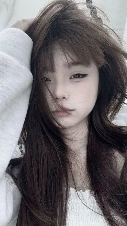 20 Hot girl tựa trong góc giường với tóc xõa rối nhẹ áo trắng đơn giản tạo vẻ mong manh và ánh mắt xa xăm