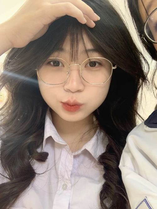 29 Ảnh gái xinh 2k7 đeo kính chụp trước gương phòng thử đồ mái tóc uốn nhẹ và son hồng làm vẻ ngoài thêm dễ mến