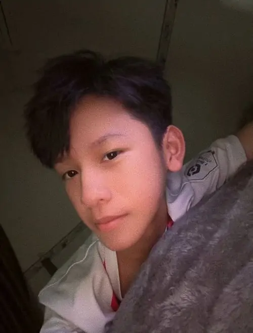 18 Chàng trai nhỏ 2012 nằm nghiêng trên giường với chăn phủ một phần vai, ánh sáng yếu và góc cận làm gương mặt trông mềm hơn, ảnh mang cảm giác dễ thương kín đáo, rất hợp kiểu filter đáng yêu nhẹ nhàng