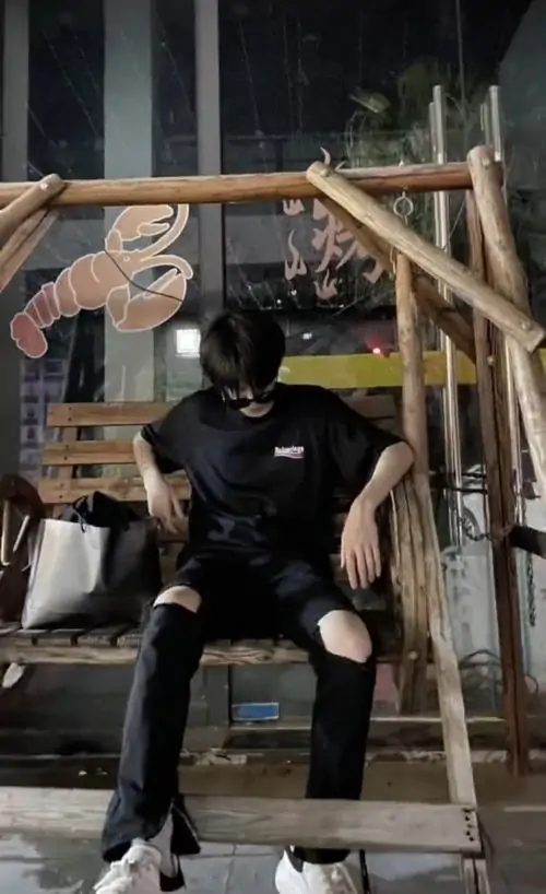 23 Hình trai ngầu ngồi giữa khung gỗ, đeo khẩu trang đen che nửa dưới gương mặt và chụp hơi từ xa, tư thế thả lỏng nhưng có lực, hợp kiểu ảnh nam thần che mặt mang nét cá tính và rất cuốn