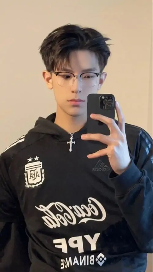 39 Hình chàng trai đẹp đeo kính trong khuôn viên trường vào buổi trưa, áo polo sáng màu và cặp sách đeo chéo khiến tạo hình trẻ trung, ánh nắng trực diện làm ảnh sáng sủa, gợi đúng tinh thần của một học bá điềm đạm