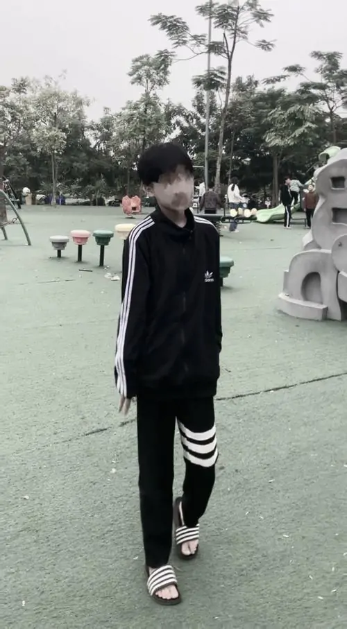 6 Đi dạo trong công viên với áo khoác đen sọc trắng quần thể thao chàng trai k9 che mặt toát lên thần thái lạnh lùng và phong cách cool ngầu.