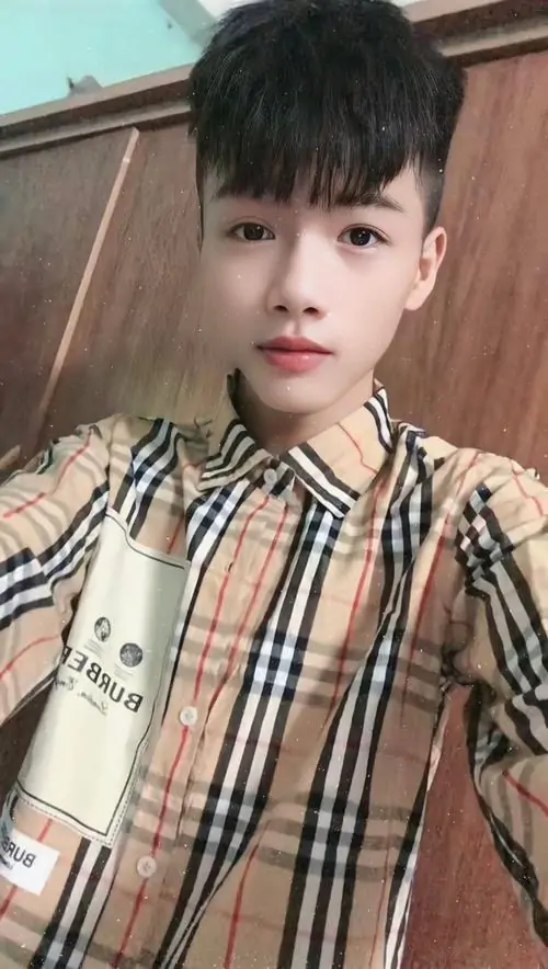 4 Hình ảnh chàng trai hotboy 2k11 với nét thư sinh và sự chững chạc ban đầu trong áo sơ mi caro đang cầm chai nước nhìn thẳng. Cậu chàng khoe gương mặt thanh tú giữa không gian thoáng đãng tạo vibe học đường hiện đại tràn đầy sức sống.