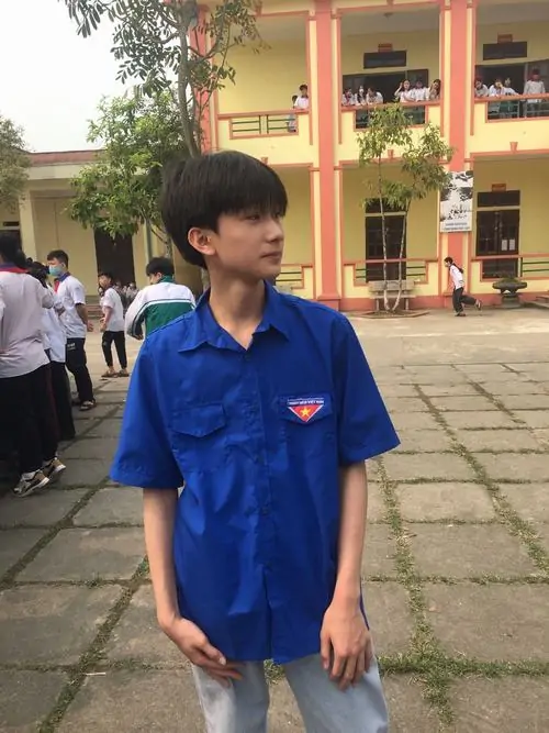 6 Nam sinh lớp 10 khoe xương hàm bắt đầu vuông vức và kiểu tóc layer gọn gàng khi đứng tay bỏ túi trong sân trường với áo polo xanh. Cậu chàng trong khoảnh khắc nam sinh năng động toát lên sự kết hợp thư sinh và thể thao đầy cuốn hút.