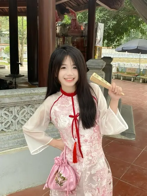 14 Trong mái hiên thoáng, nàng váy trắng phối nơ đỏ cười tươi bên túi nhỏ